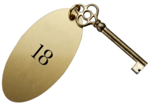 A classic key attached to an oval gold pendant with the number 18.